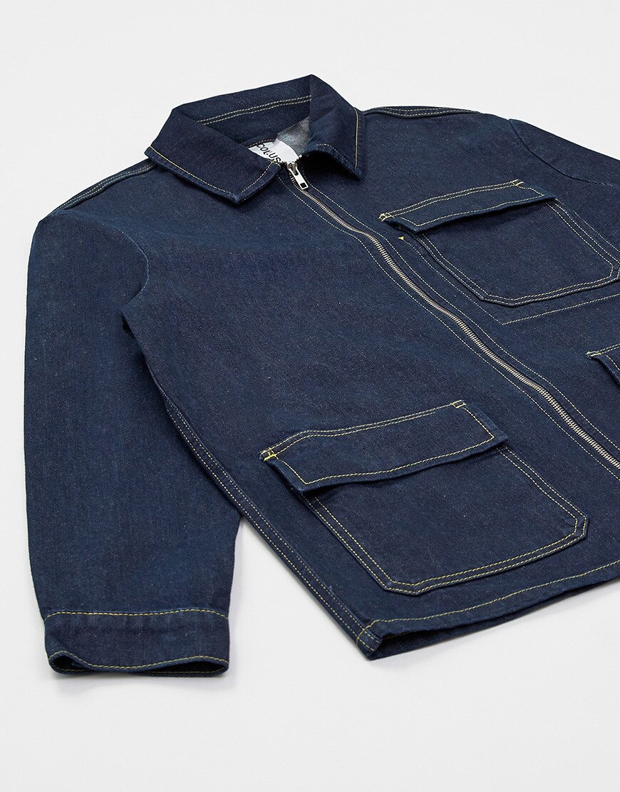A close-up picture of an indigo worker-style denim jacket. Available at ASOS.