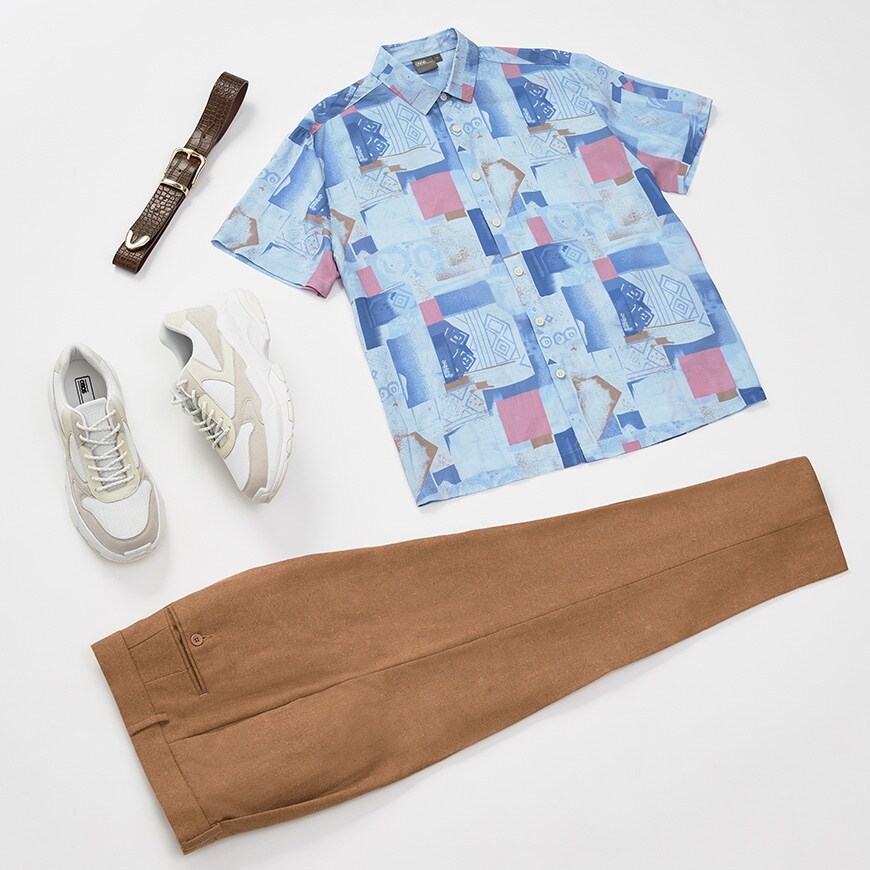 A flat lay outfit to go out for dinner in featuring a printed shirt, tan-coloured trousers with white, chunky trainers. Available at ASOS.