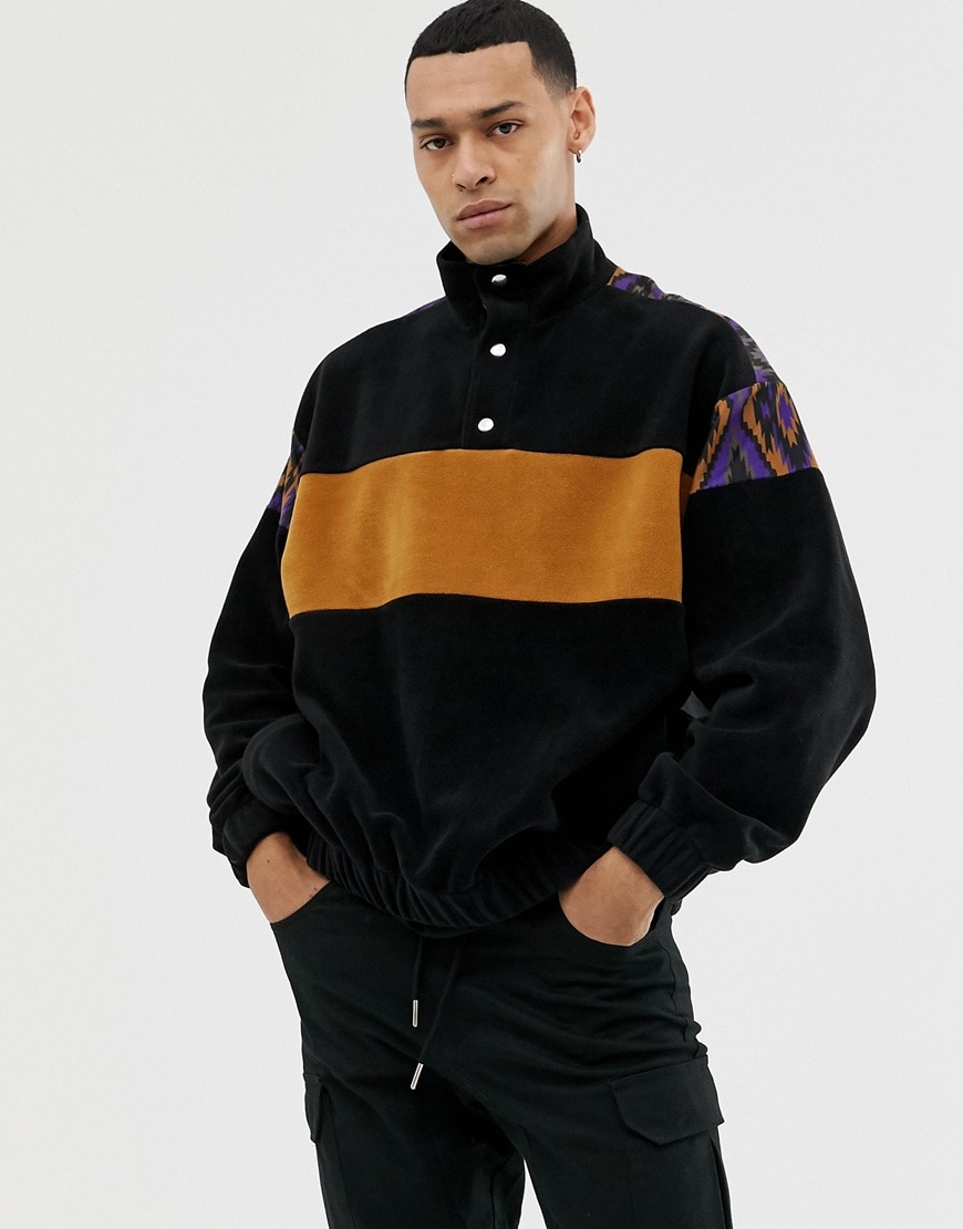 A picture of a man wearing an oversized sweatshirt by ASOS DESIGN. Available at ASOS.