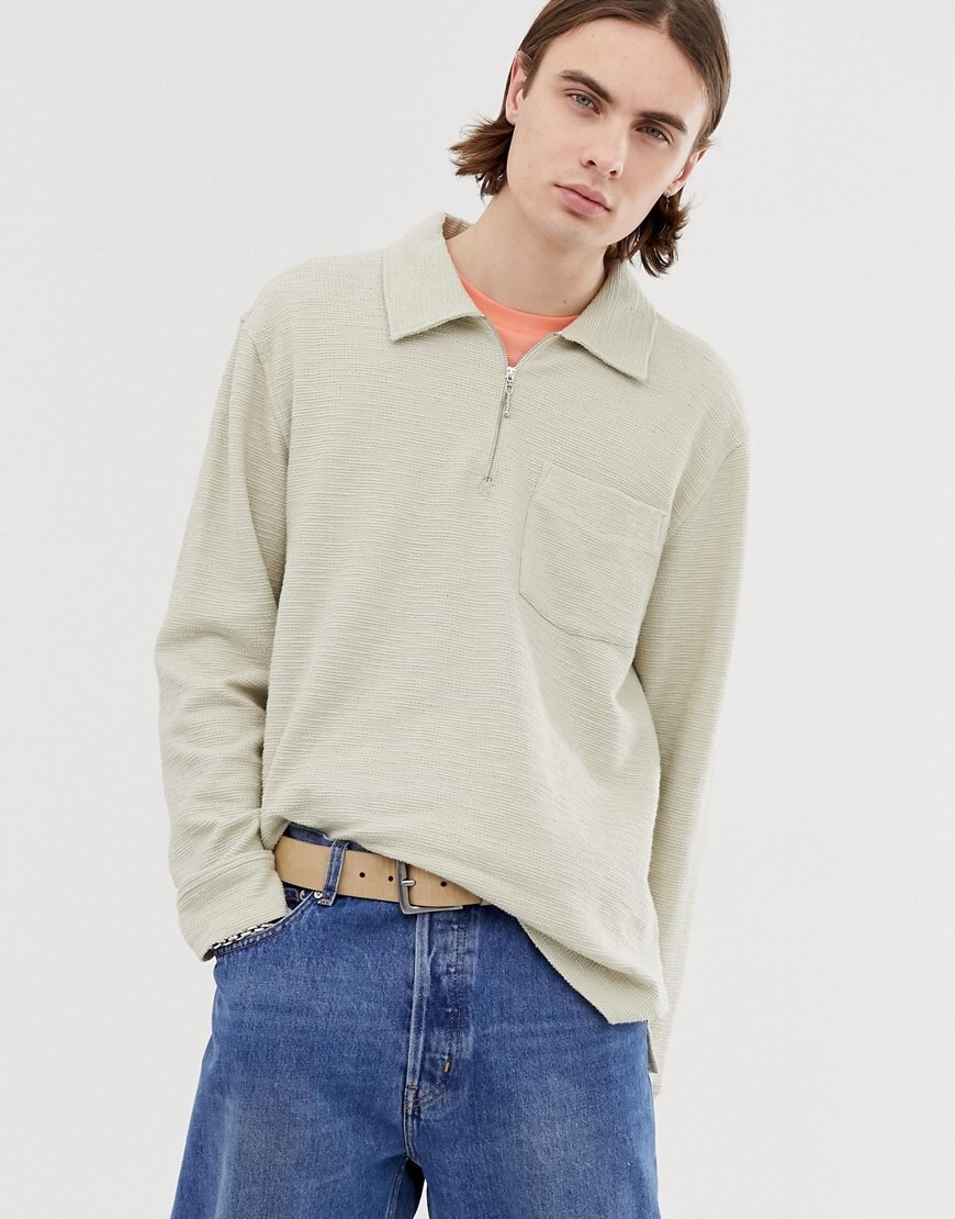 A picture of a man wearing a half-zip, collared sweatshirt from Weekday. Available on ASOS.