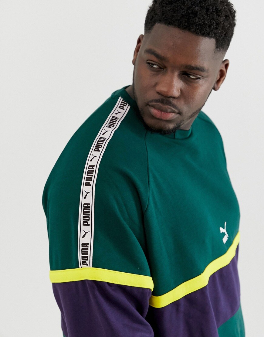 A picture of a man wearing a plus-size PUMA sweatshirt. Available at ASOS.