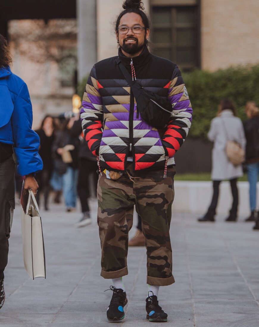A picture of a street styler wearing a colour-blocked puffer and camo trousers.
