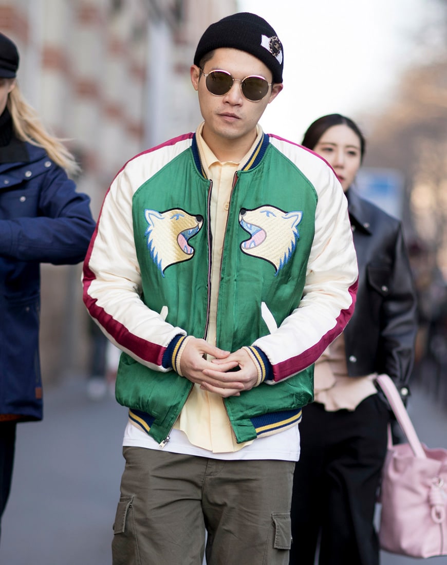 A picture of a street styler wearing a varsity-style jacket.