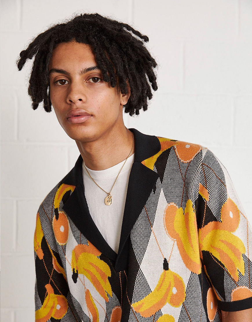 A picture of a man wearing a vibrant short-sleeve jumper. Available at ASOS.