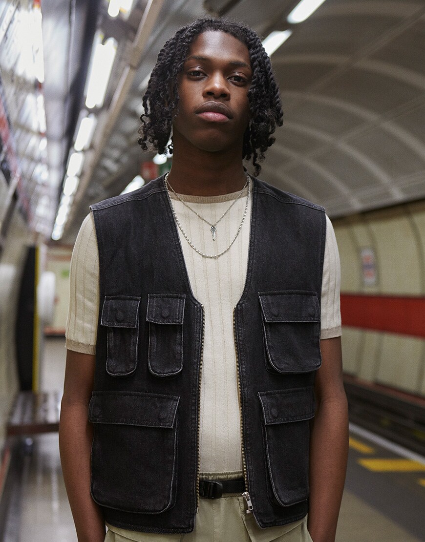 A picture of a man wearing a utility-style gilet and T-shirt by ASOS DESIGN. Available at ASOS.