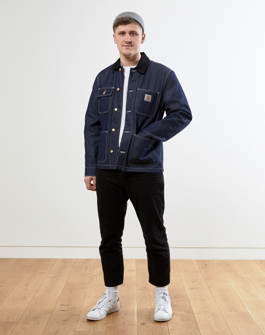 A picture of a man wearing a Carhartt WIP denim chore jacket. Available at ASOS.