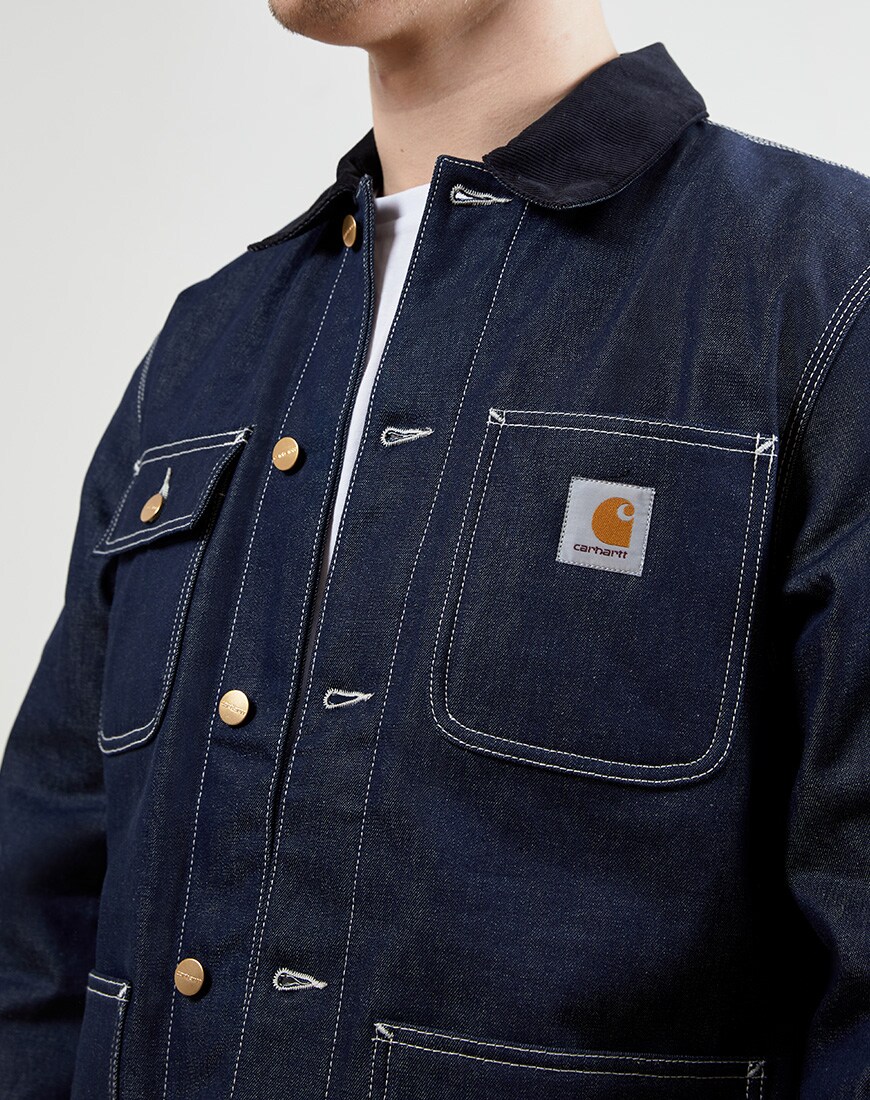 A close up picture of a denim chore jacket from Carhartt WIP. Available at ASOS.