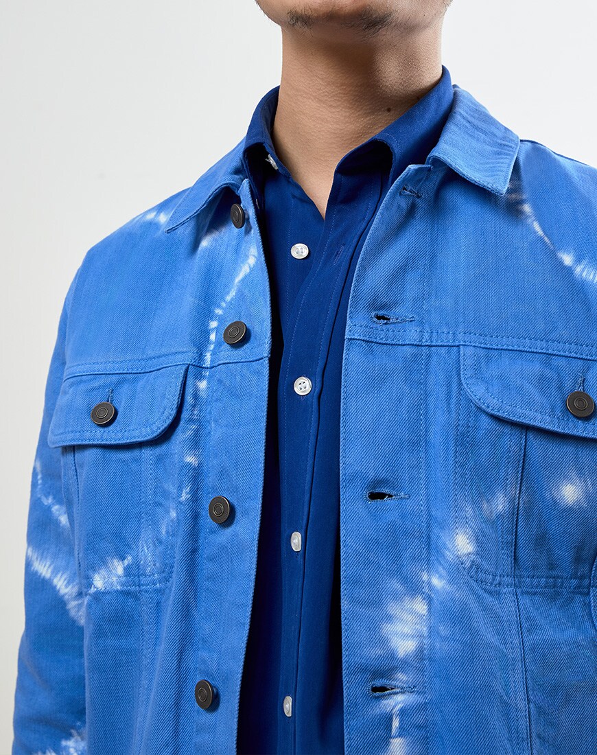 A close up picture of a blue tie-dye denim jacket. Available at ASOS.