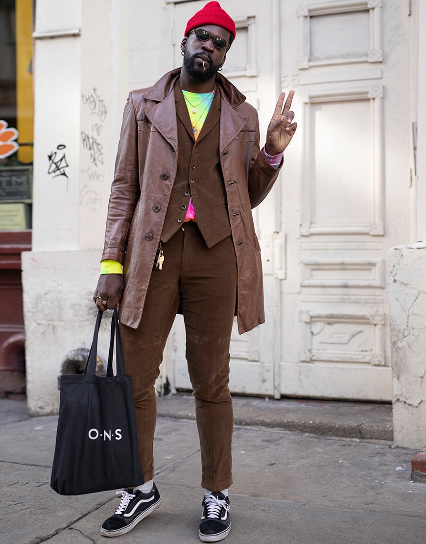 A picture of a street styler wearing a brown leather jacket.