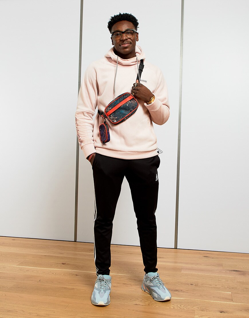 A picture of a man wearing a printed cross-body bag. Available at ASOS.