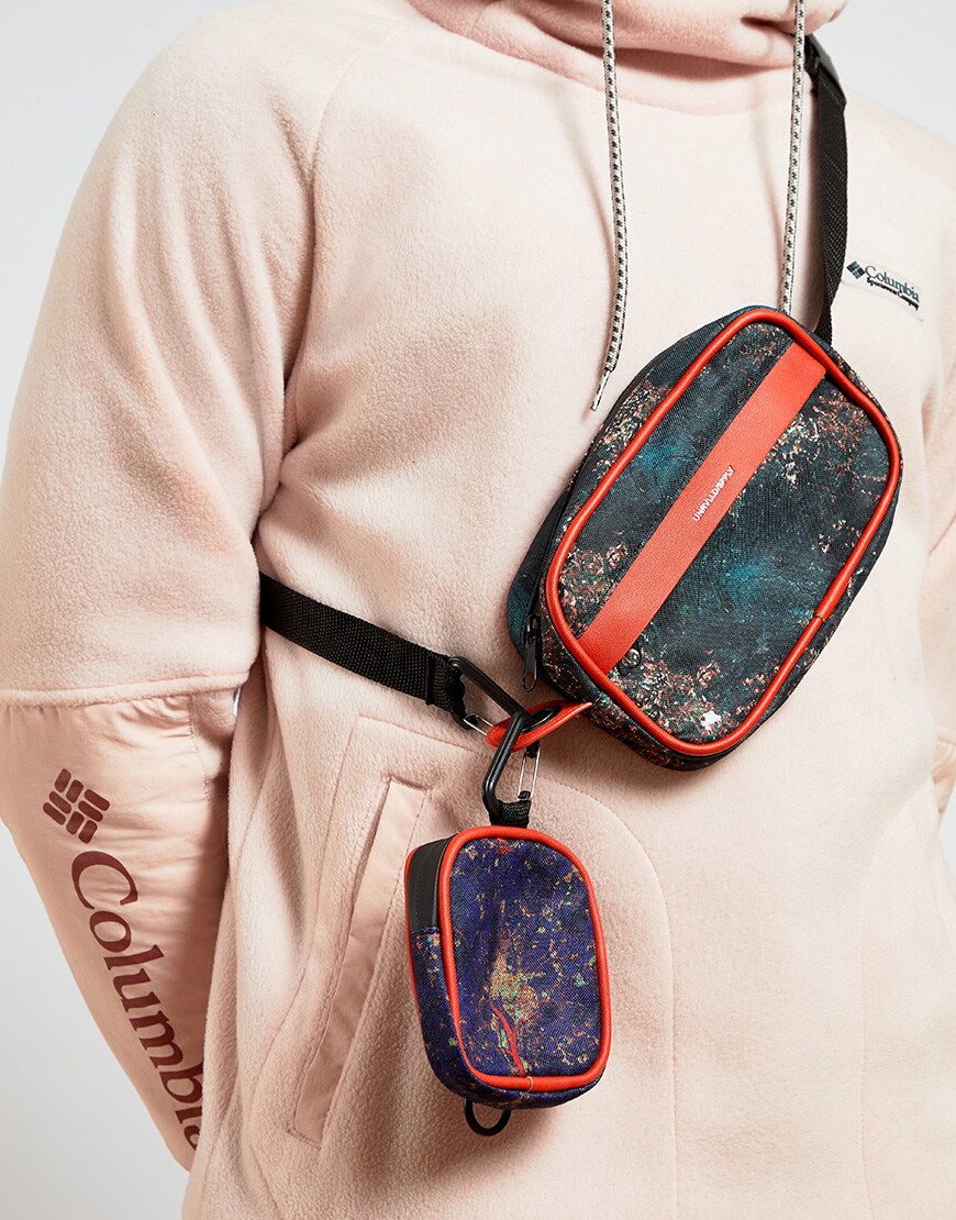 A picture of a man wearing a printed cross-body bag. Available at ASOS.