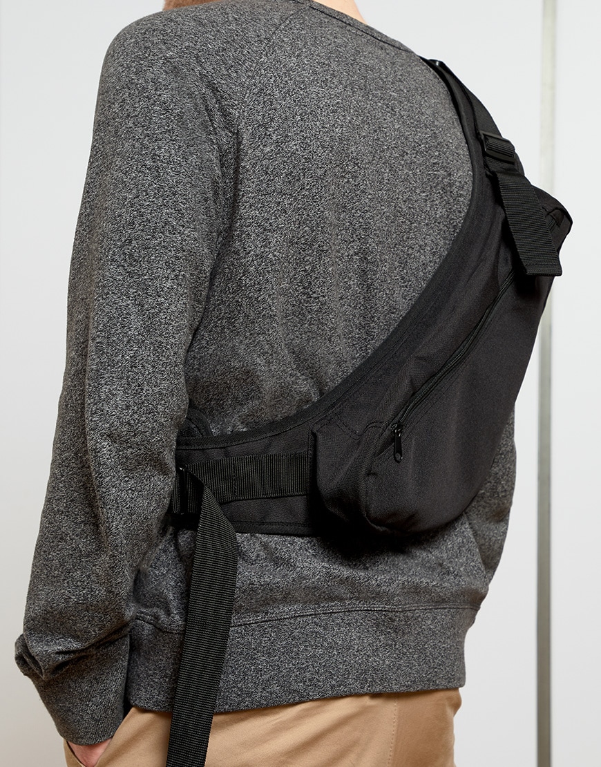 A picture of a man wearing a black cross-body bag. Available at ASOS.