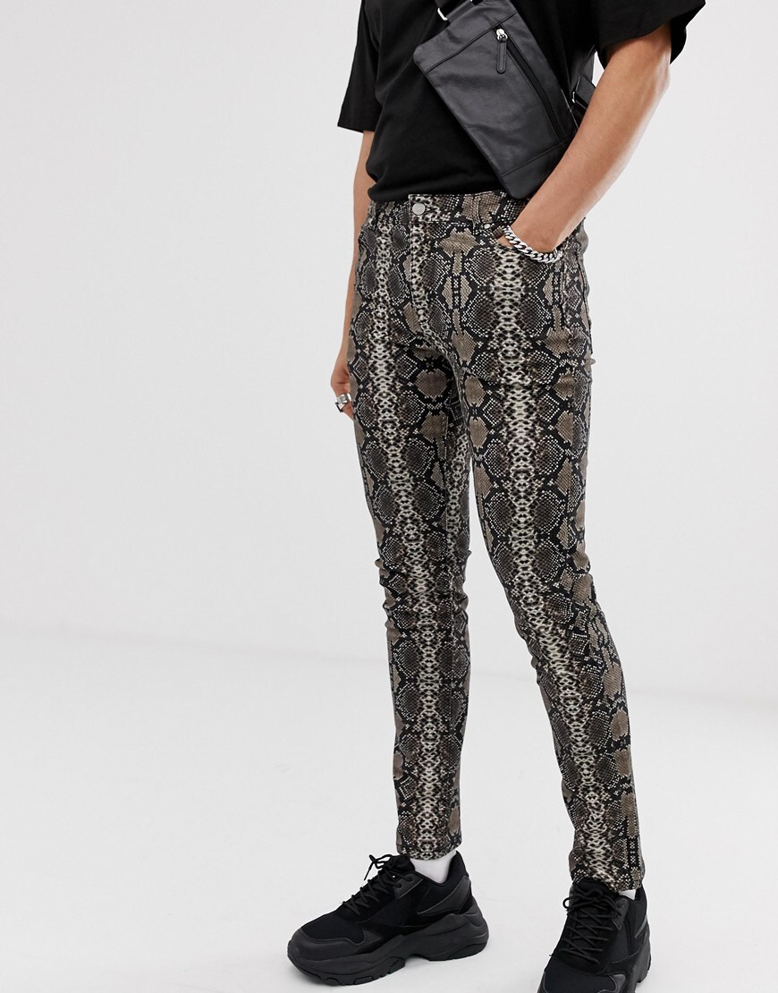A picture of a model wearing skinny fit jeans featuring an all-over snakeskin print. Available at ASOS.