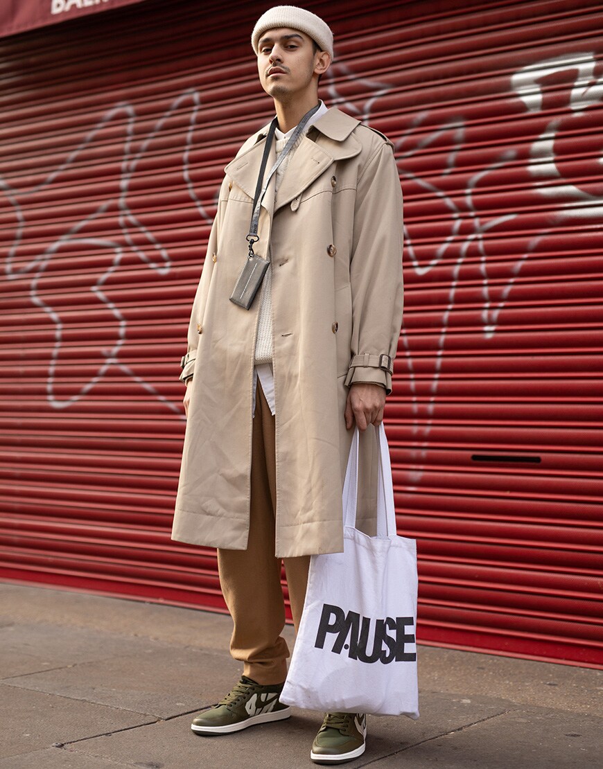 A picture of a street styler wearing a lightweight coat.