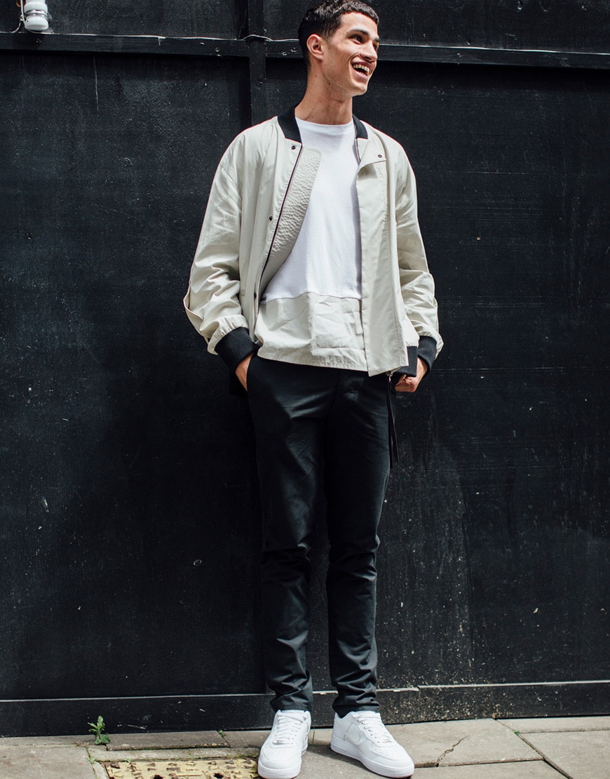 A picture of a street styler wearing white trainers.