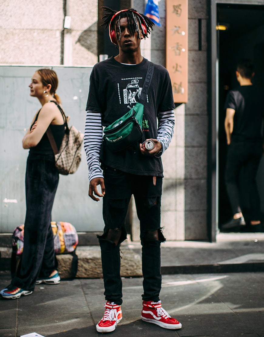 A picture of a street styler wearing a bum bag.