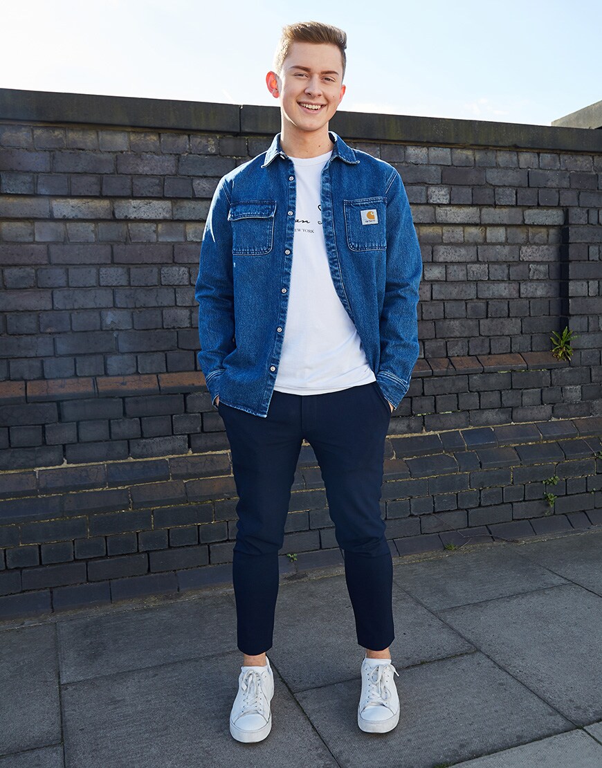 A picture of an ASOSer wearing a Carhartt WIP denim overshirt, a white T-shirt and cropped, black trousers.