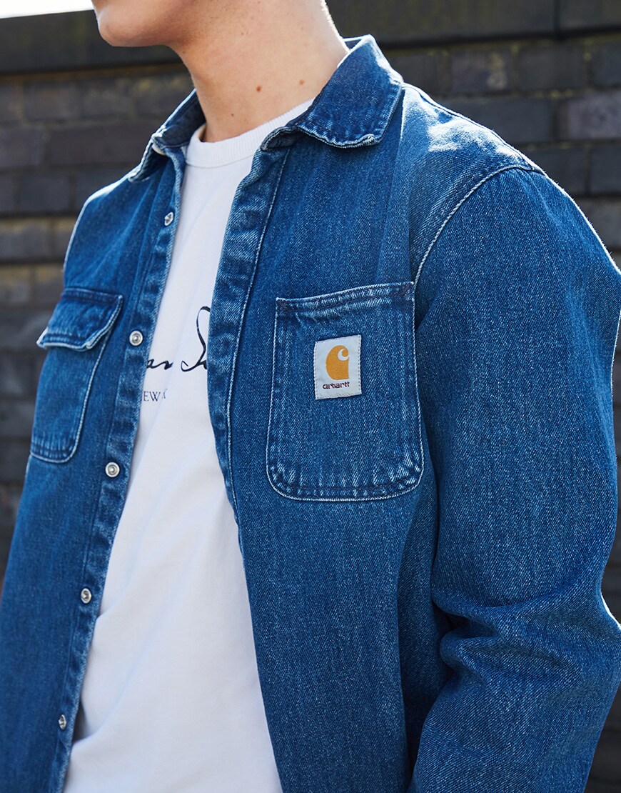 A picture of an ASOSer wearing a denim shacket from Carhartt WIP with a white T-shirt.