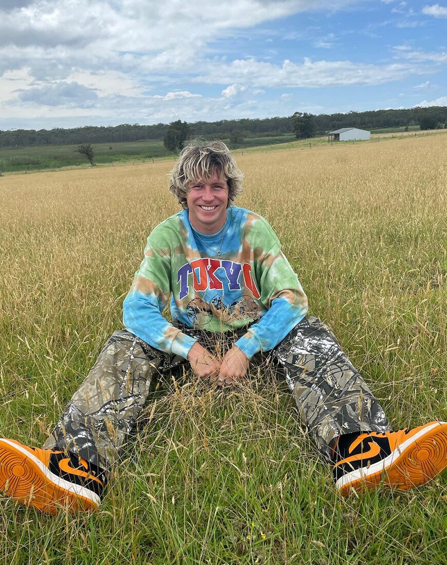 A picture of a steet styler wearing a tie-dye T-shirt.