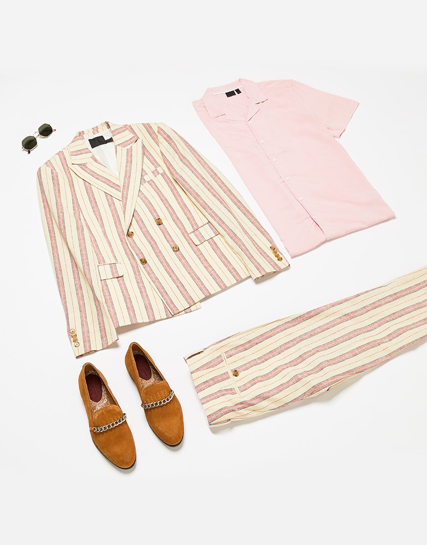 A flat lay of a wedding outfit featuring a pink and white striped suit and accessories. Available at ASOS.