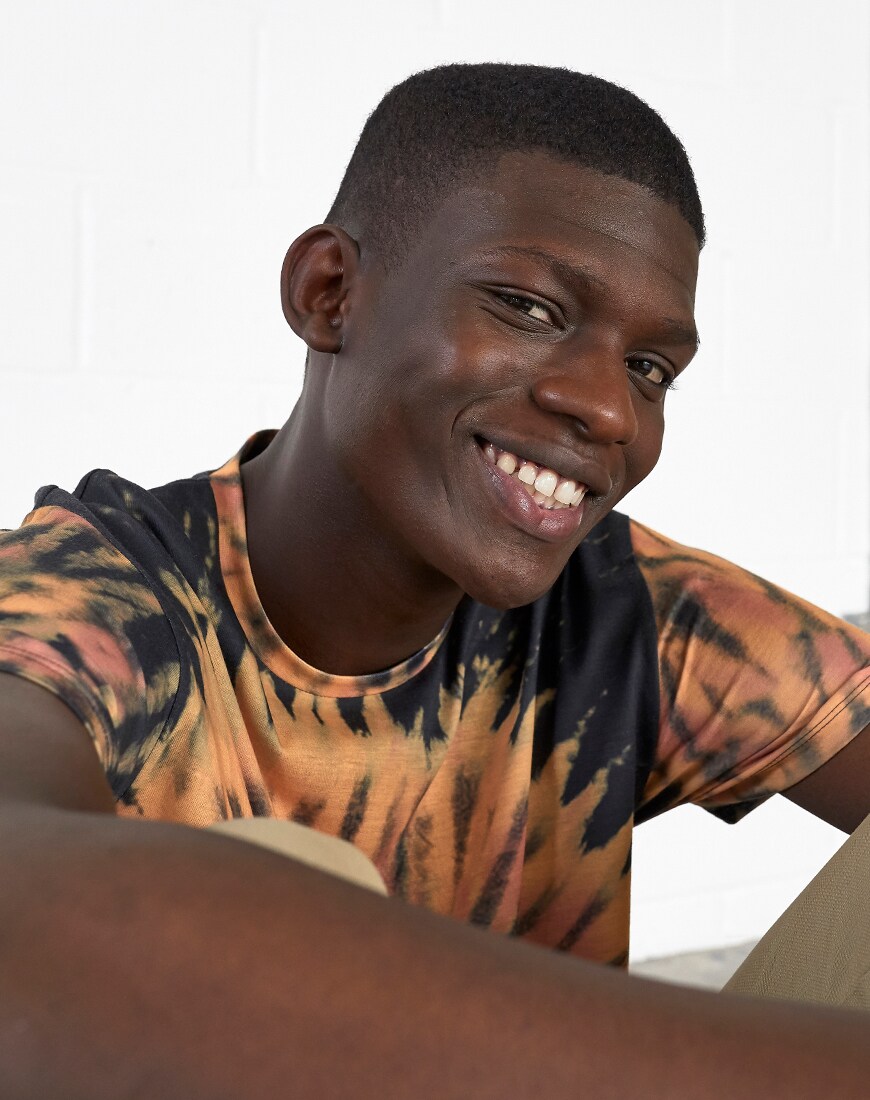 A picture of a model wearing a brown and black tie-dye T-shirt. Available at ASOS.