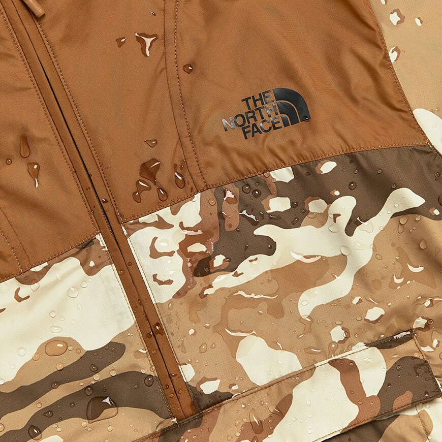 A close-up picture of a camo-print rain jacket by The North Face. Available on ASOS.