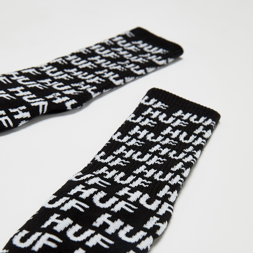 A picture of a pair of HUF socks featuring and all-over logo print. Available at ASOS.