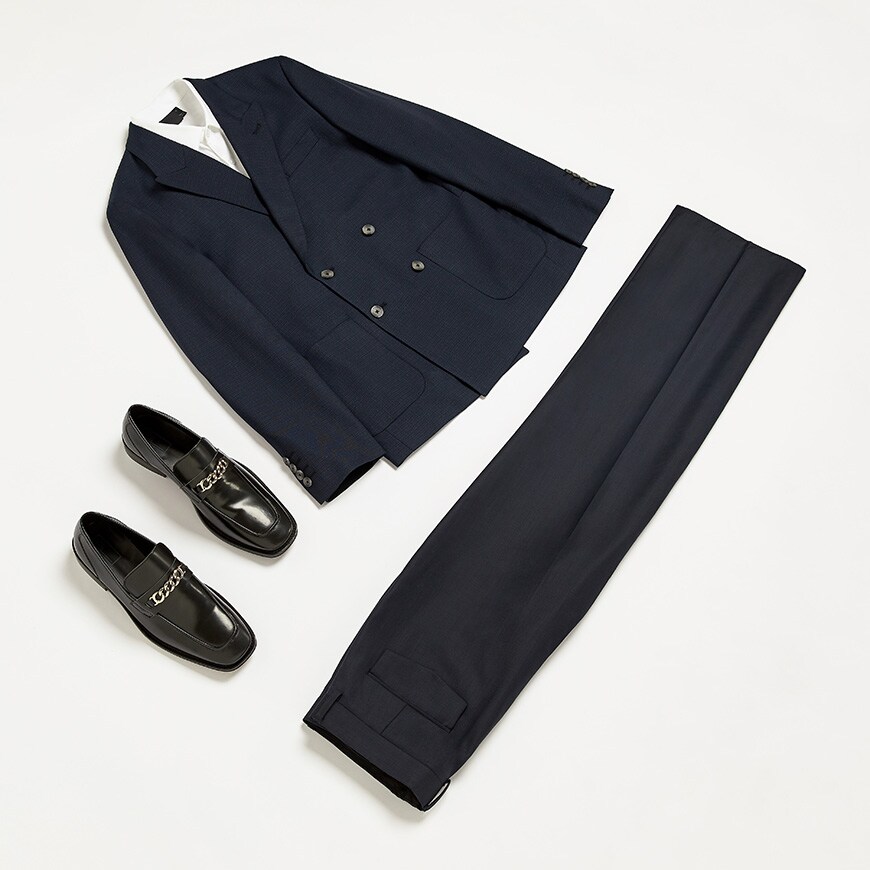 A wedding outfit flat lay featuring a double-breasted navy blazer and wide-cut trousers. Available at ASOS.