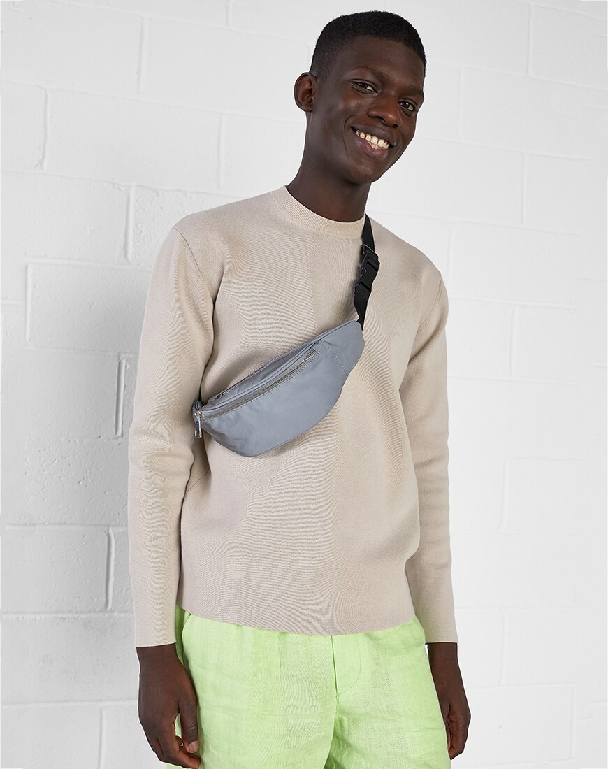 A picture of a model wearing a lightweight knit and washed-neon shorts. Available at ASOS.