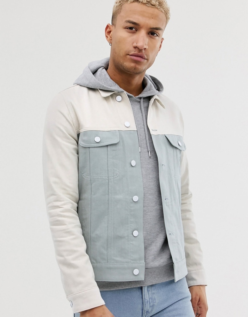 A picture of a model wearing a colour-block denim jacket. Available at ASOS.