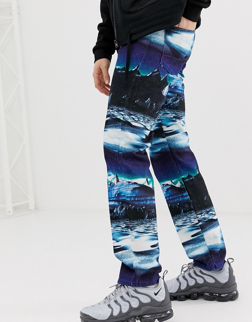 A picture of a model wearing space-print jeans by ASOS DESIGN. Available at ASOS.com