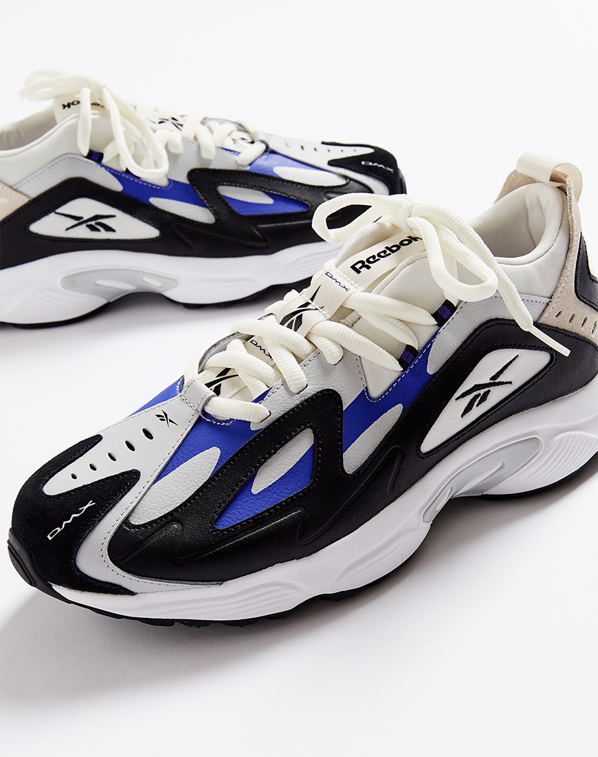 A picture of a pair of Reebok Daytona DMX trainers in black, blue and white. Available at ASOS.