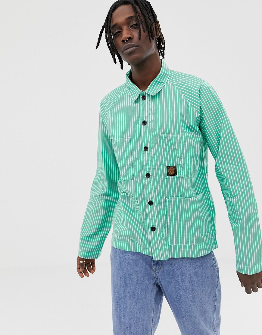 A picture of a model wearing a green and white overshirt by Kings Of Indigo. Available at ASOS.