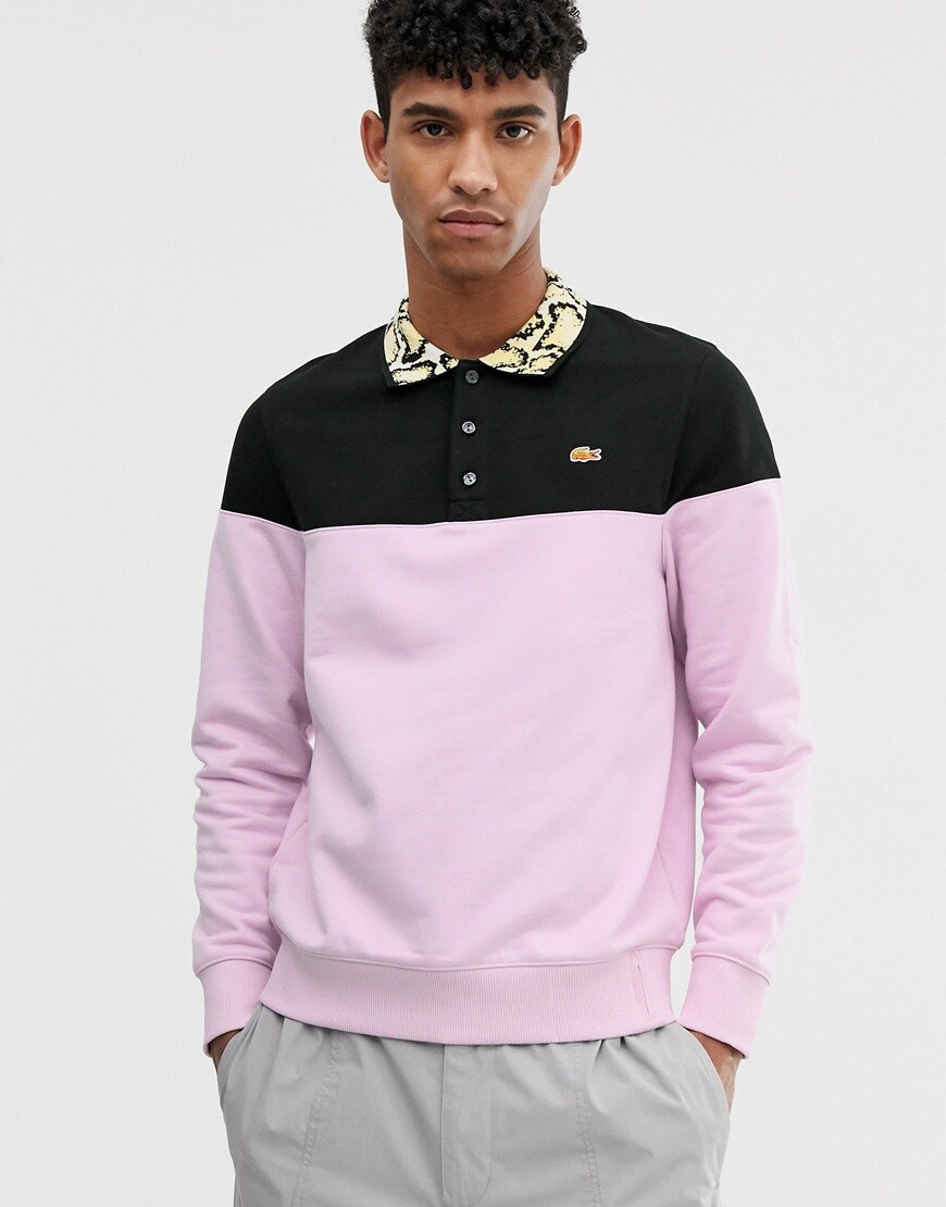 A picture of a model wearing a coloir-blocked Lacoste X Opening Ceremony sweatshirt. Available at ASOS.