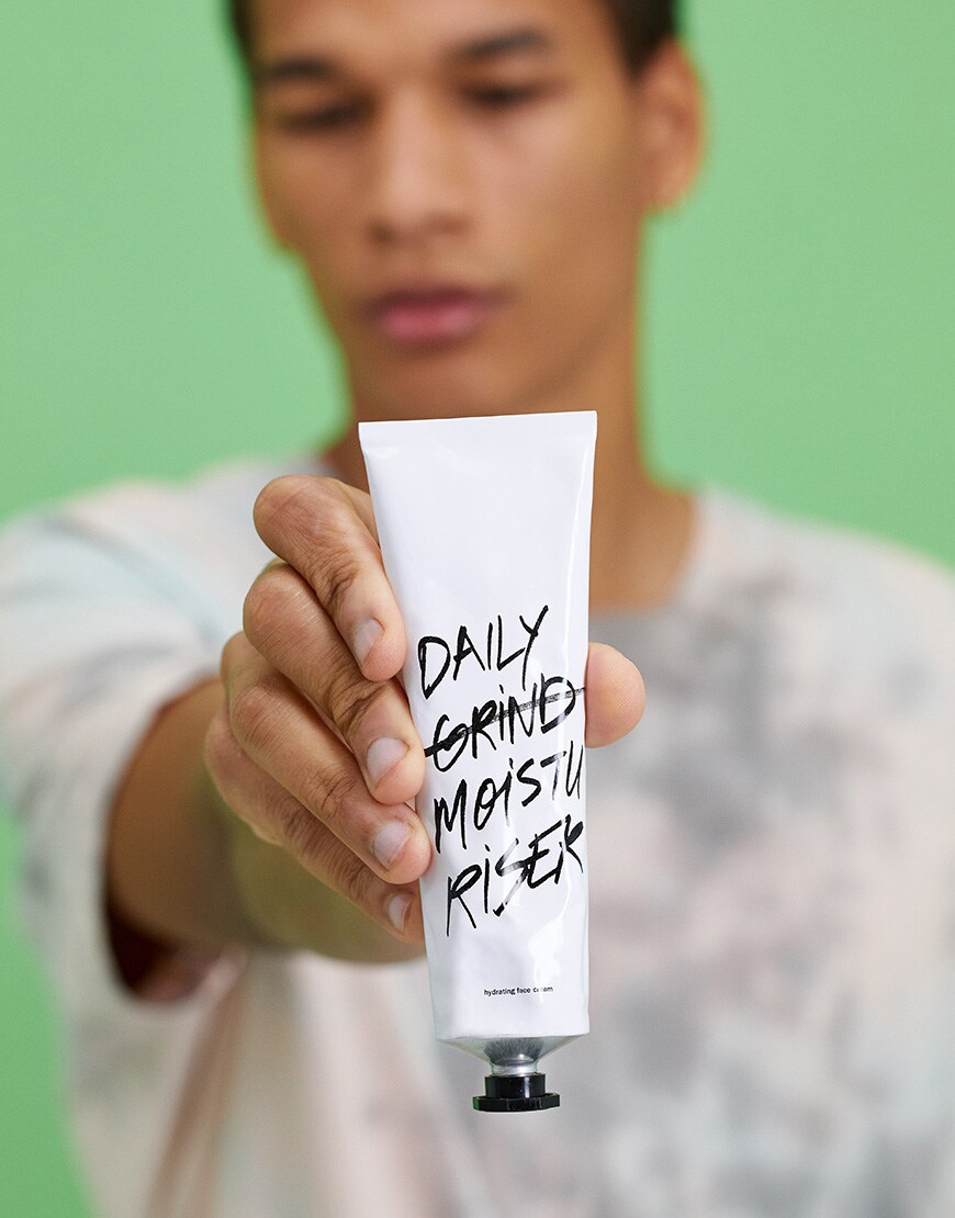 A picture of a model holding some hydrating face cream from Do-ers of London. Available at ASOS.