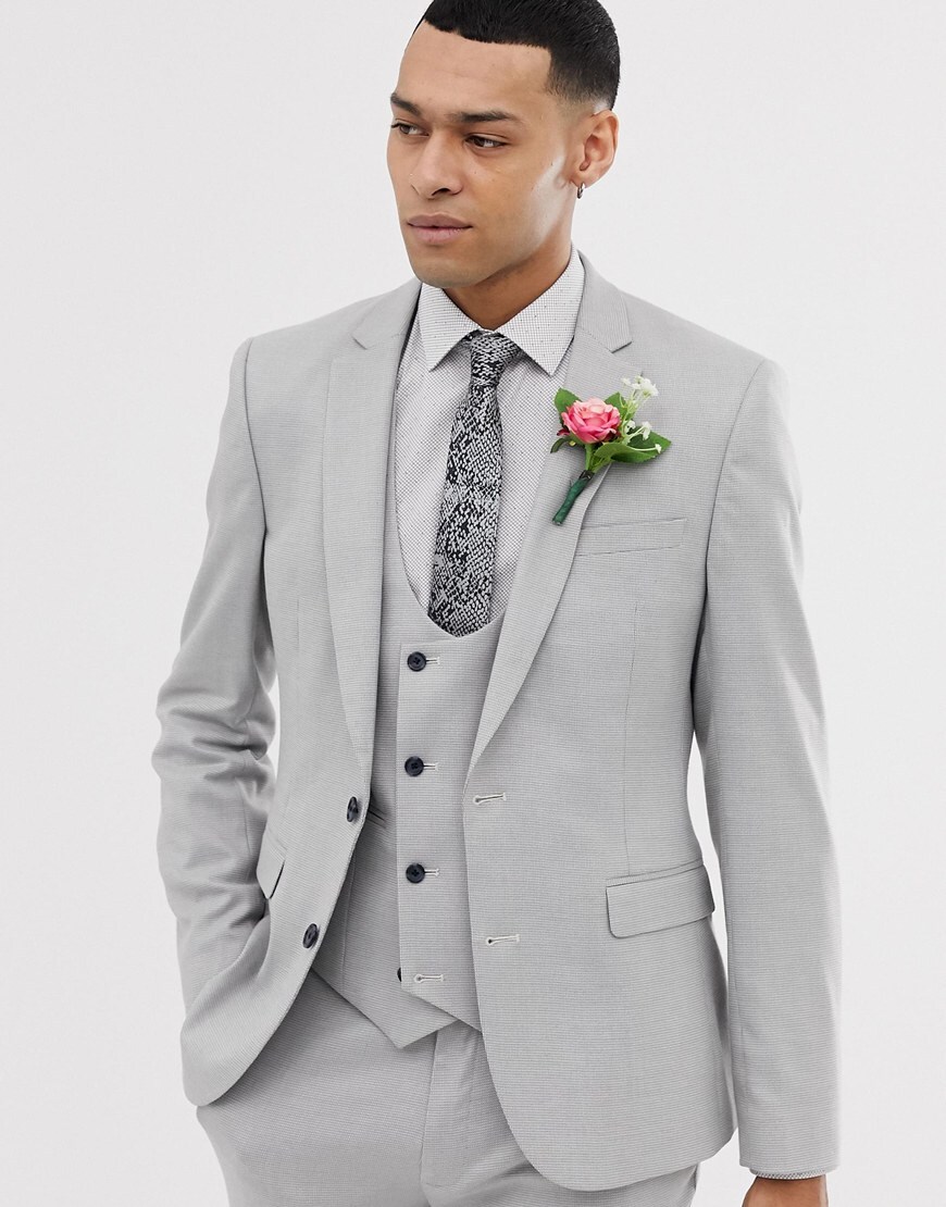 A picture of a model wearing a grey three-piece suit. Available at ASOS.
