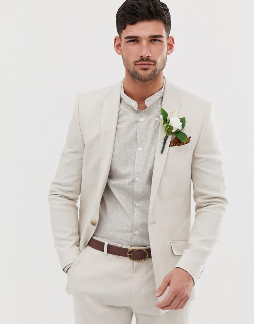 A picture of a model wearing a beige linen-mix suit. Available at ASOS.