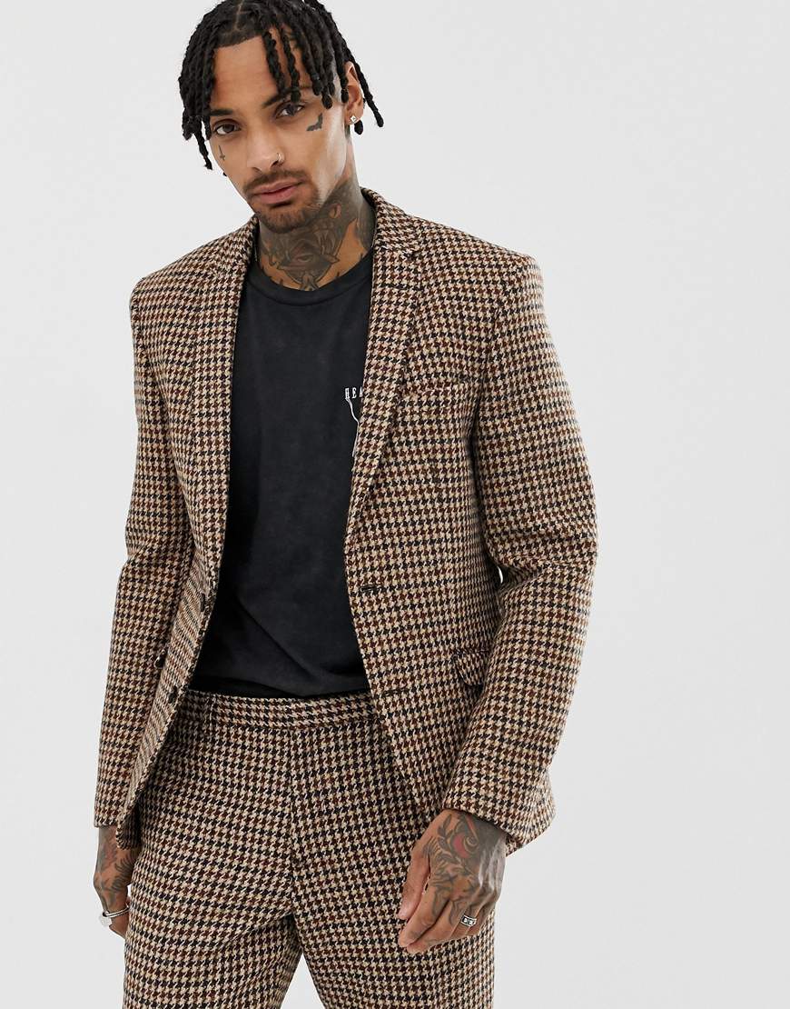A picture of a model wearing a tweed blazer and trousers. Available at ASOS.