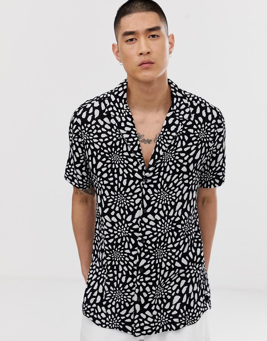 A picture of a model wearing printed revere-collar shirt. Available at ASOS.