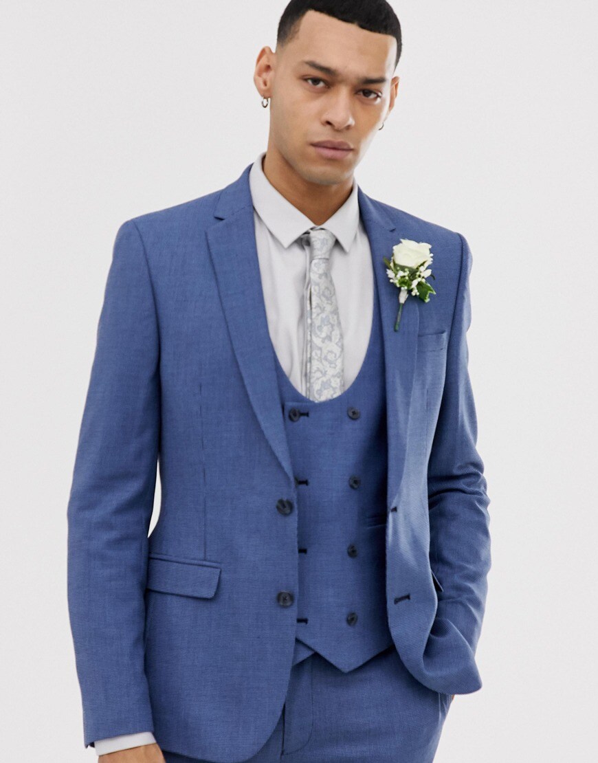A picture of a model wearing a bright blue textured suit. Available at ASOS.