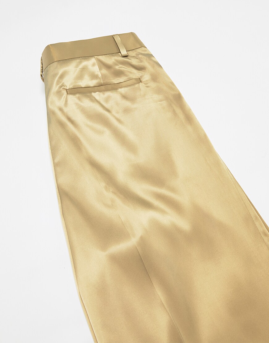 A picture of a pair of gold-tone, satin-style trousers. Available at ASOS.