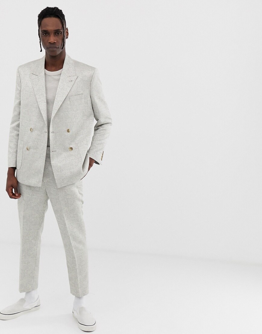 A picture of a model wearing a silver jacquard suit. Available at ASOS.