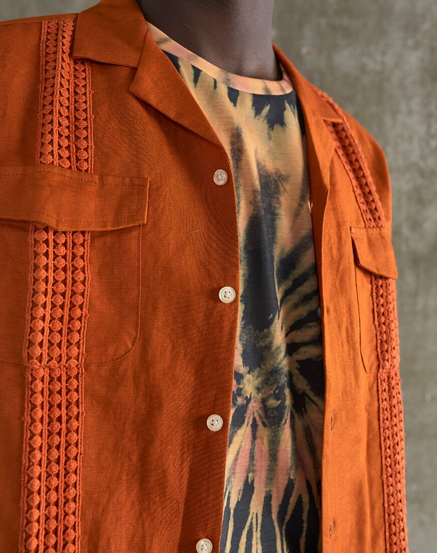 A close-up picture of a crochet shirt and tie-dye T-shirt. Available at ASOS.