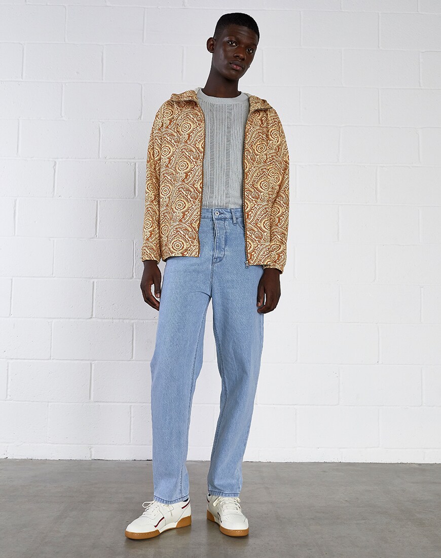 A picture of a model wearing a paisley print jacket, light-wash jeans and a waffle-texture jumper. Available at ASOS.
