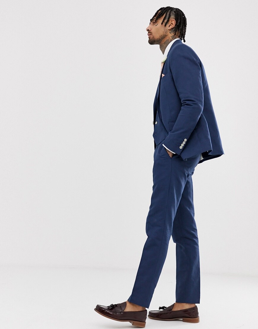 A picture of a model wearing a blue suit and brown loafers. Available at ASOS.