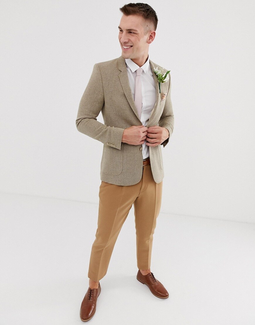 A picture of a model wearing a taupe blazer with tan-coloured trousers and brown brogues. Available at ASOS.