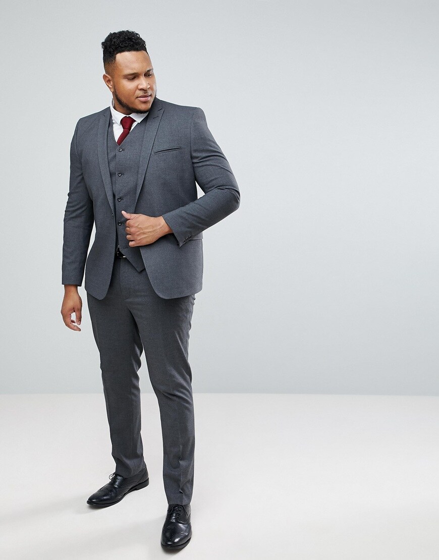 A picture of a model wearing a charcoal suit and black shoes. Available at ASOS.
