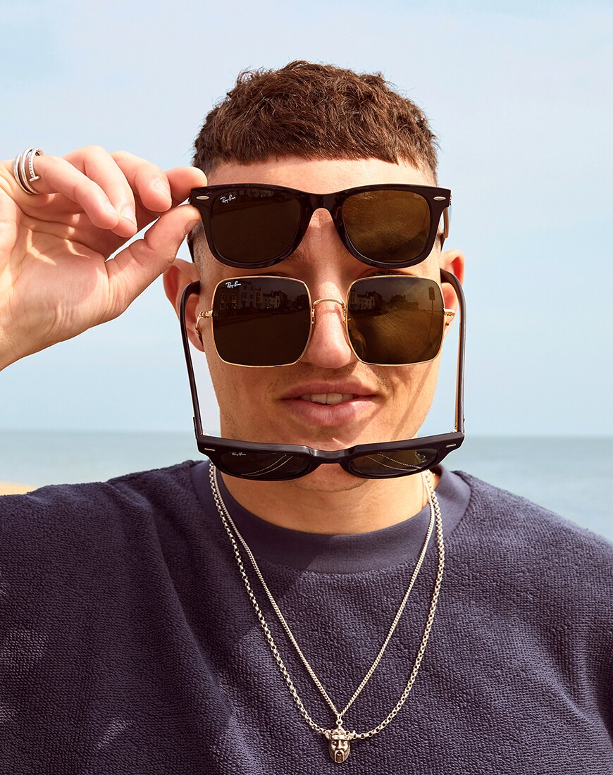 A picture of an ASOS Insider wearing three pairs of sunglasses by Ray-Ban.