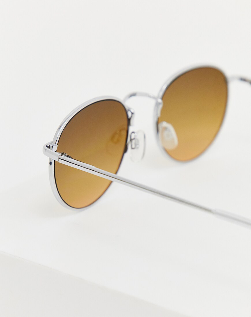 A picture of a pair of silver round lens sunglasses. Available at ASOS