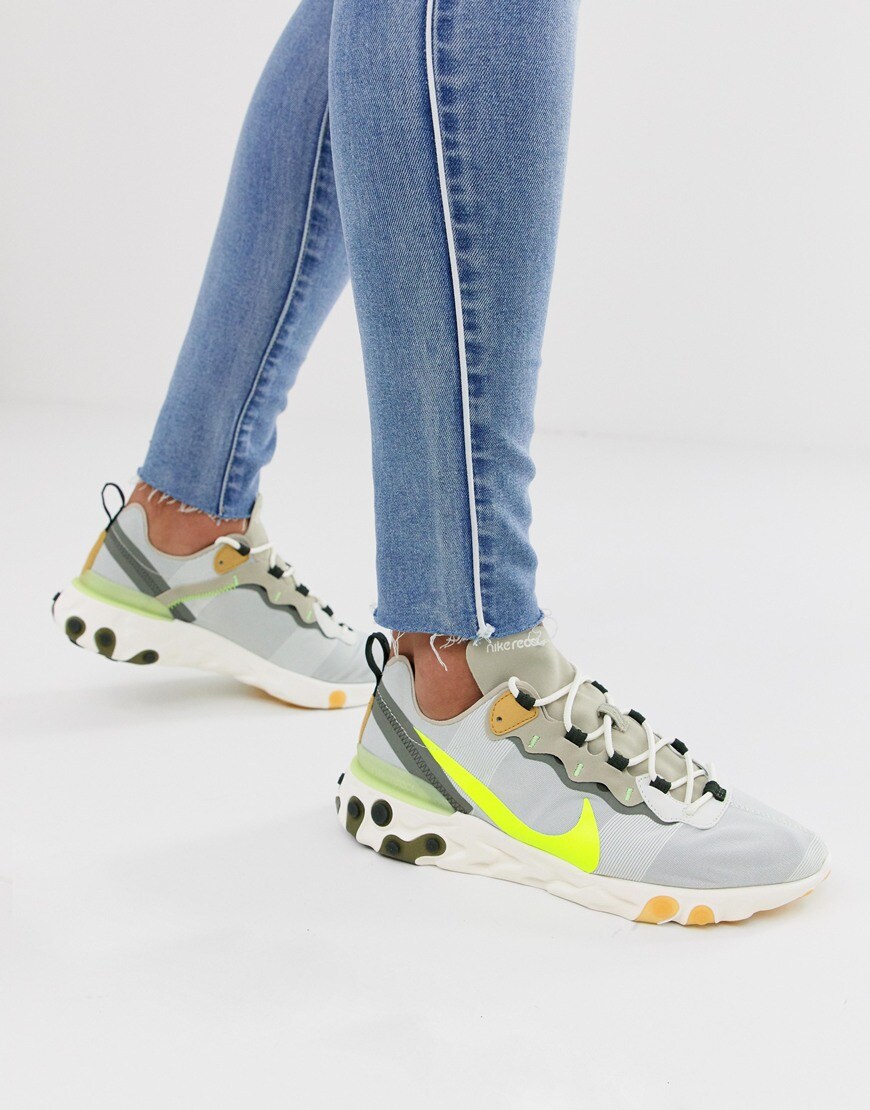 A picture of a model wearing a pair of Nike React 55 trainers. Available at ASOS.